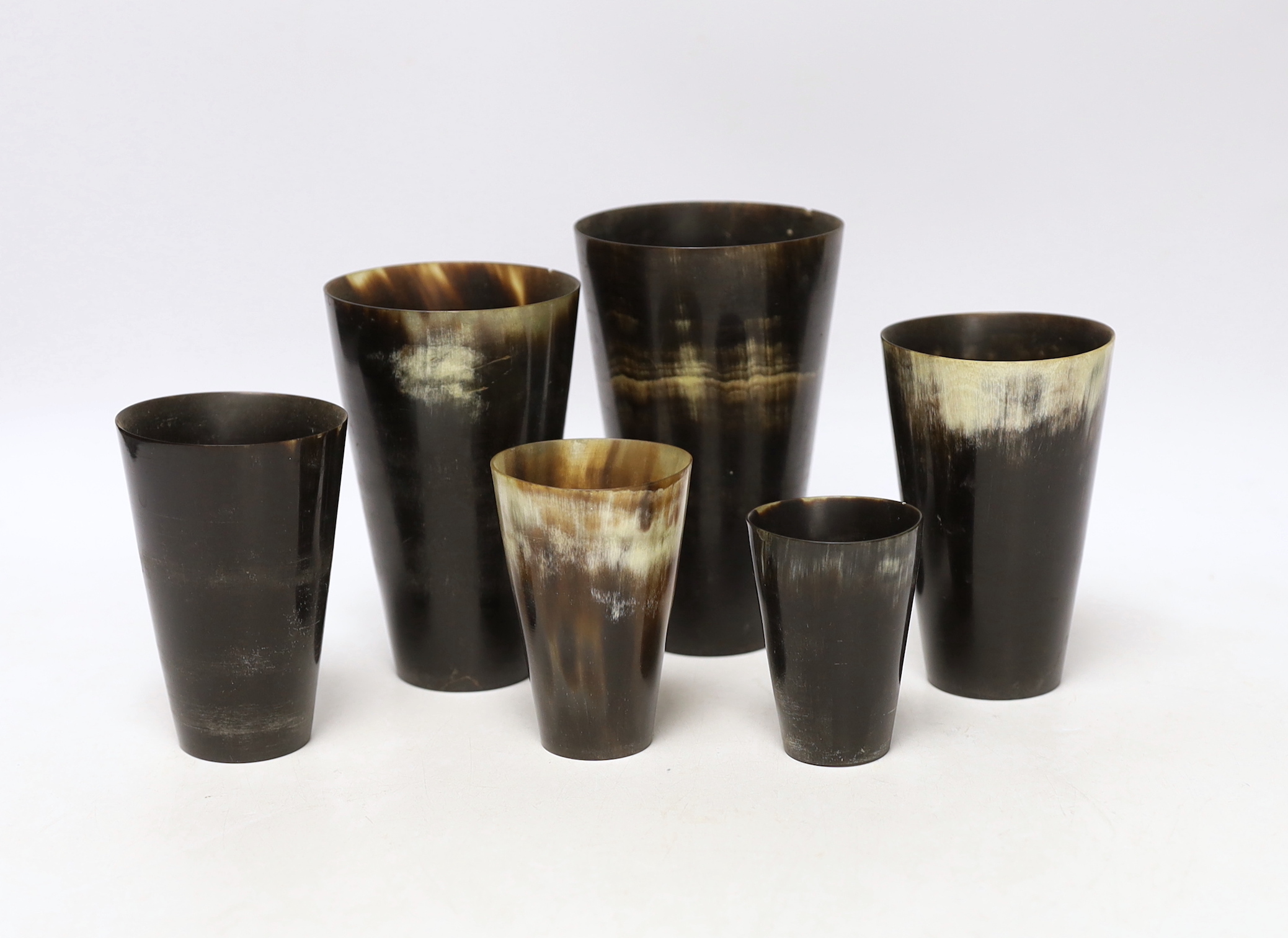 A graduated set of six Victorian horn beakers, largest 12.5cm